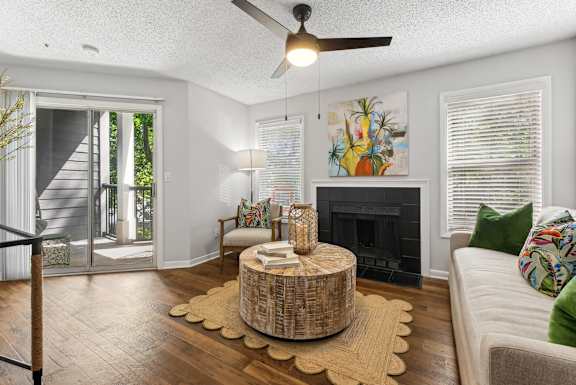 A living room with a fireplace and a painting on the wall.
