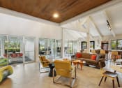 Thumbnail 9 of 13 - a living room with couches chairs and tables and glass doors