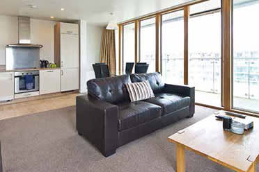 a living room with a leather couch and a coffee table