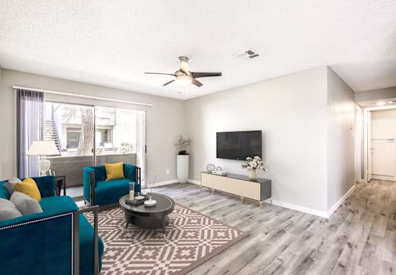 A living room with a blue couch and a television.