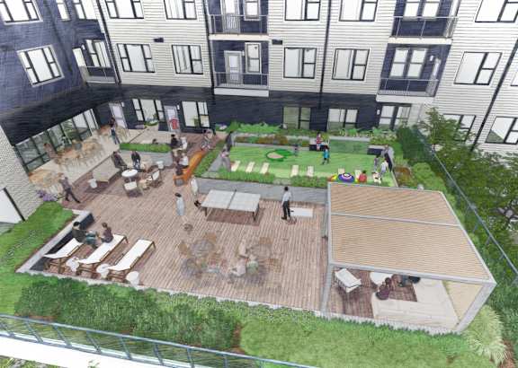 A rooftop garden with a seating area and a green lawn.