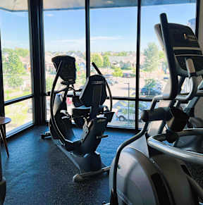 A gym with treadmills and elliptical machines.