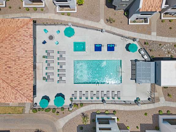 arial view of a building with a large swimming pool