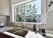 Thumbnail 4 of 18 - a kitchen with a sink and a window at 8535 Colgate-Fully Furnished Apartments, Los Angeles