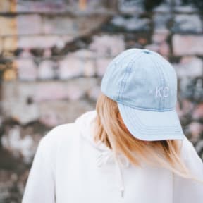 Woman Wearing Light Blue KC Hat