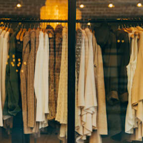 Clothes hanging in a store window.