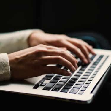 Person Typing on Laptop