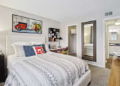 Thumbnail 6 of 13 - a bedroom with a bed and a mirror
