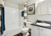 Thumbnail 5 of 13 - a bathroom with a toilet and a sink and a tub