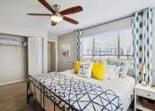 Thumbnail 4 of 13 - a bedroom with a large bed and a ceiling fan