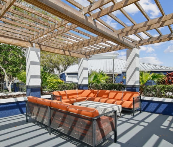 a covered patio with a couch and a table