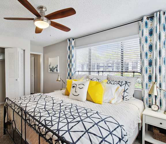 a bedroom with a large bed and a ceiling fan