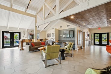 a living room with couches and chairs and a television