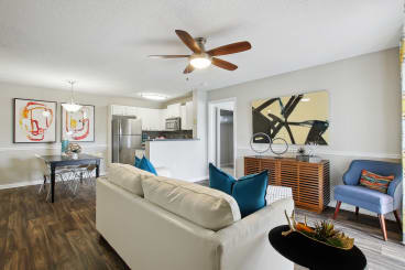 a living room with a couch and a ceiling fan