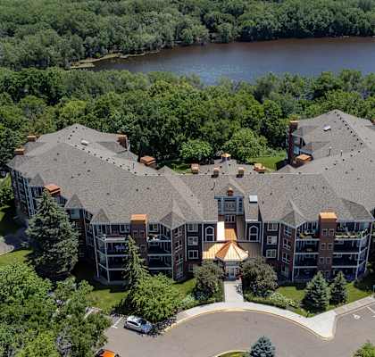 an aerial view of a large building next to a river
