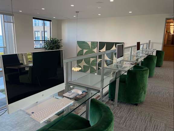 A modern office space with green chairs and a glass table at 42 Hundred On The Lake, St Francis, Wisconsin, 53235
