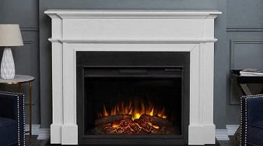 White painted fireplace with burning logs