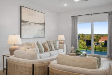 A living room with two couches and a painting on the wall.