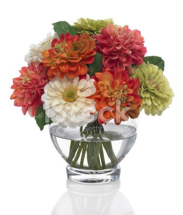 a bunch of flowers in a glass vase