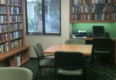 fully-stocked library at Casa Santa Marta I Senior Apartments in Sarasota, FL