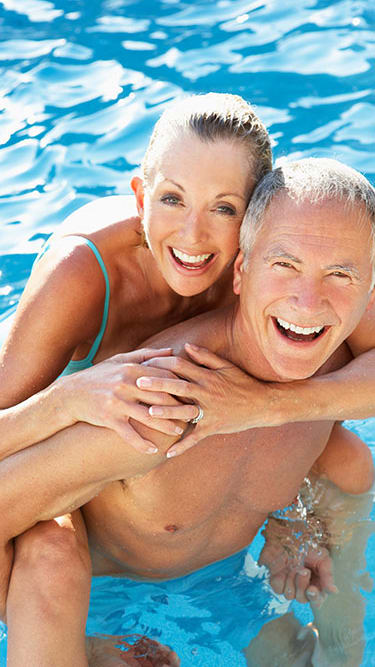Couple in the pool at Palm Park Apartments, Boynton Beach, 33060
