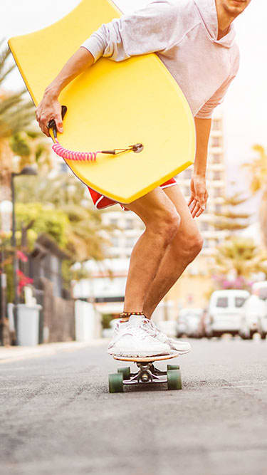 Man skateboarding with surf board  Aqua 2800 Apartments in Oakland Park Florida