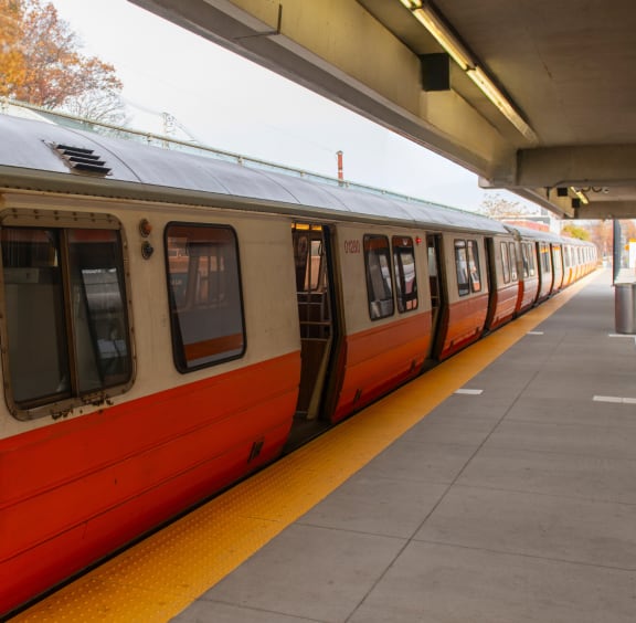 a red and white train at a train station
