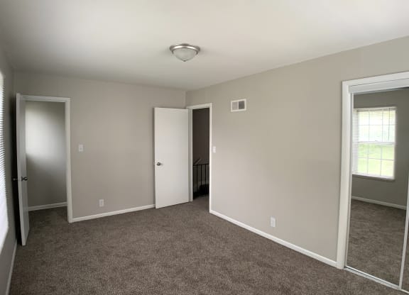Spacious bedroom with mirrored closets