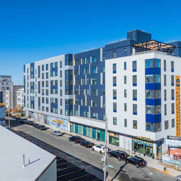 A modern building with a flat roof and large windows is depicted in the image.at The Indie, Boston, MA 02134