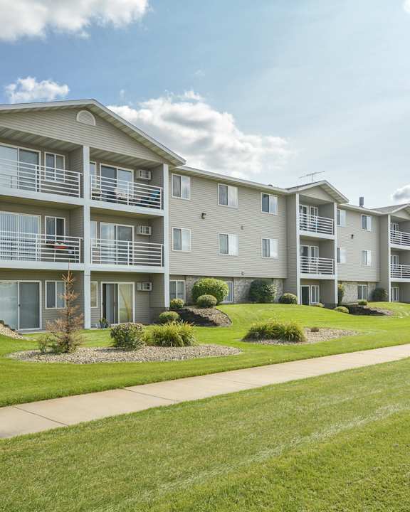 an exterior view of an apartment building on a sunny day