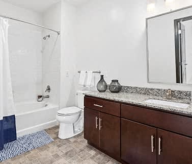 a bathroom with a toilet and a sink and a shower