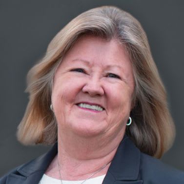 a woman wearing a suit and a tie