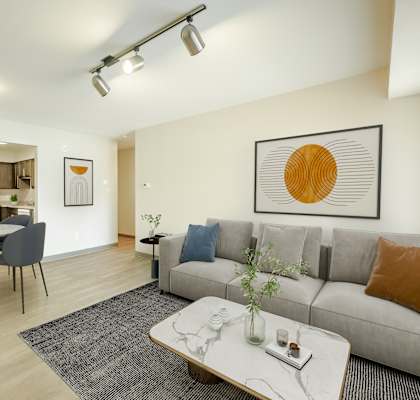 a living room with a couch and a table with chairs