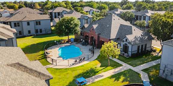 an aerial view of a large house with a swimming pool
