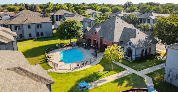 an aerial view of a large house with a swimming pool