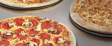 Three pizzas with different toppings are displayed on plates.