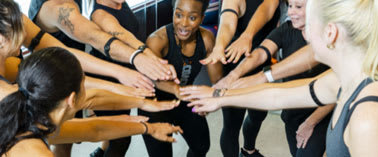 A group of people in a circle holding hands.