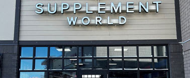 Supplement World store front with large sign.