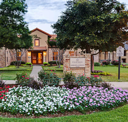 a flower garden in front of a building