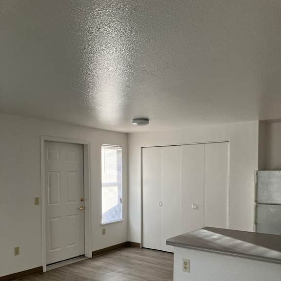 A white door with a window above it.