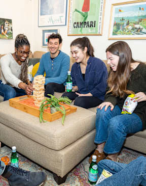 Four people playing Jenga in a living room. at The Commonwealth Building, Pittsburgh, 15222