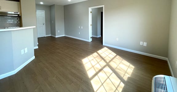A room with wooden floors and a ceiling fan.