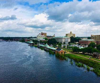 A river flows through a city with buildings on both sides.