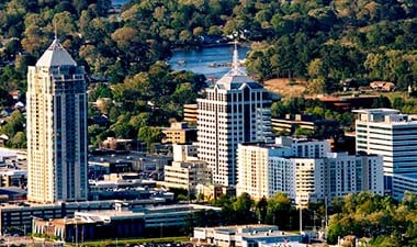 a city skyline with a river in the background