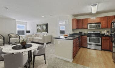 a kitchen and living room with a table and chairs