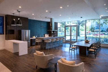 a large living room with a kitchen and a table and chairs at Sinclaire on Seminary, Alexandria, VA