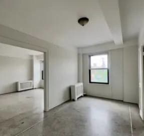 a bedroom with a bed and a door to a bathroom