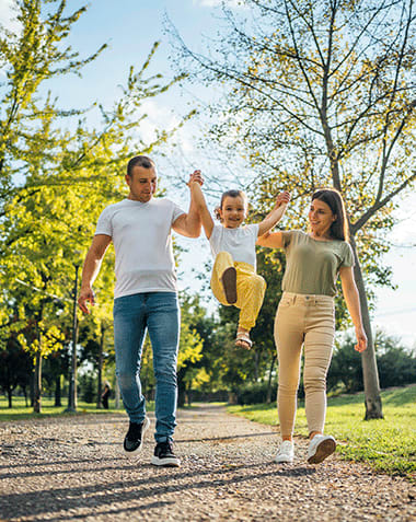 Lifestyle photo of a family walking on a nature path