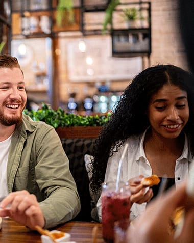 a man and woman sitting at a table at a restaurant