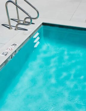 a swimming pool with a ladder next to it